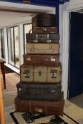 A collection of vintage luggage to include a brown leather suitcase,