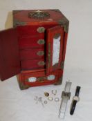 A modern Chinese table top jewellery cabinet with pierced brass embellishments containing a tigers