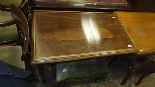 A rectangular mahogany side table with open undertier, raised on turned legs,