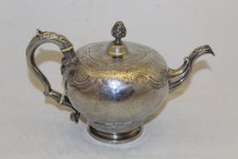 A Georgian silver teapot with embossed acanthus and floral decoration and pineapple finial,