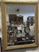 A large rectangular giltwood and gesso framed wall mirror