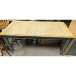 A beech topped rectangular extending dining table with teal painted base