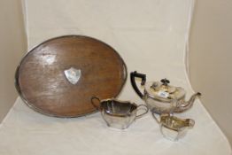 An Alex Clarke Company Limited Welbeck plate three piece tea set and a plated and oak oval drinks