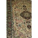 A modern Persian silk rug, the central medallion in dark blue, cream, green and pale blue,