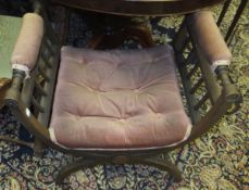 An Edwardian mahogany and inlaid X framed dressing stool with pink velvet upholstery to the seat