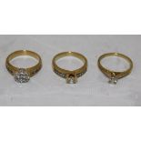 A collection of three 18 carat gold and white stone set dress rings