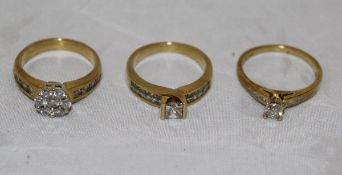 A collection of three 18 carat gold and white stone set dress rings