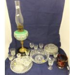 A collection of glassware to include a Victorian oil lamp with green glass bowl painted with