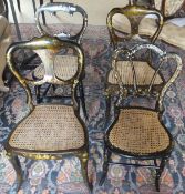 A pair of Victorian ebonised and cane seated salon chairs with painted decoration depicting flowers