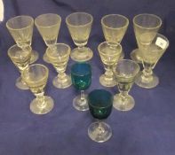 A collection of six early 19th Century facet cut glass wines with conical shaped bowls,