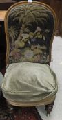 An early Victorian nursing chair with needlework back,