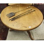 A circular pine breakfast table raised on a single pedestal to tripod base,