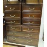 A modern mahogany chest of two short and two long drawers, two bedside chests of three drawers,