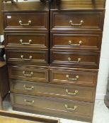 A modern mahogany chest of two short and two long drawers, two bedside chests of three drawers,