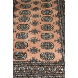 A Bokhara rug, the repeating elephant foot medallions in blue / grey,