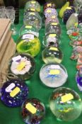 A collection of sixteen glass paperweights to include examples with bubble decoration,