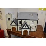 A 20th Century doll's house in the form of a timber framed building,