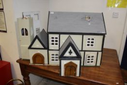 A 20th Century doll's house in the form of a timber framed building,