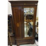 An Edwardian mahogany and fan marquetry inlaid single door wardrobe with drawer below,
