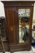 An Edwardian mahogany and fan marquetry inlaid single door wardrobe with drawer below,