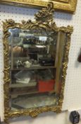 A floral and gilt decorated mirror and another gilt decorated mirror (2)