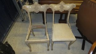 A pair of 19th Century painted Empire style dining chairs
