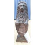 A pair of cast iron lion ornaments in the form of a lion seated on it's haunches,