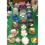 A collection of paperweights and glass ornaments to include two etched globe paperweights,