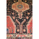 A Caucasian rug, the central medallion in pale red,