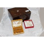 A mahogany box containing various 9 carat gold and other earrings, some set with stones, pearls,