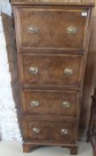 A 19th Century walnut cross-banded narrow chest four deep drawers with applied moulding oval drop