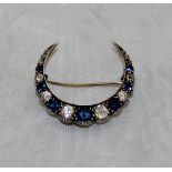 A Victorian sapphire and diamond three-quarter crescent brooch set with nineteen graduated stones,