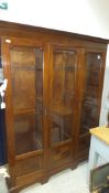 An Edwardian mahogany and satinwood strung three section bookcase,