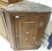 A 19th Century fruitwood wall hanging corner cabinet with single door,