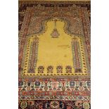 A Persian prayer rug, the central Mirhab in pale gold, within dark blue, cream,
