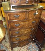 A 20th Century walnut bow fronted chest of two short and four long drawers,