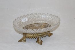 An early 19th Century cut glass fruit bowl on an early Victorian foliate pierced gilt metal stand