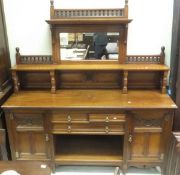 A walnut mirror backed sideboard with three drawers, open recess,