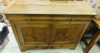 A 19th Century French cherrywood cupboard, the plain top above two drawers,