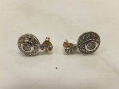 A pair of diamond set earring,