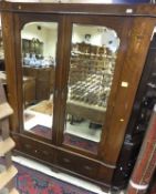 An Edwardian mahogany and inlaid double mirror door wardrobe with two drawers