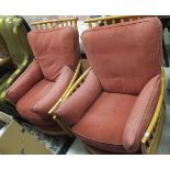 Two Ercol armchairs with terracotta upholstered seats and backs,