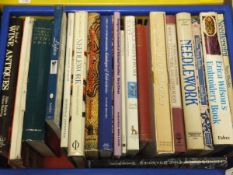 Two boxes of assorted hardback books relating to textiles, needleworks, alcohol,