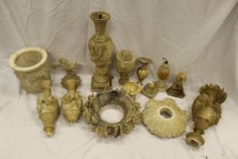 A collection of carved stone ornaments to include two lamp bases, vases,