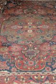 A Caucasian rug, the central medallion in terracotta, cinnamon, cream, pale gold and blue,