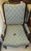 A Edwardian salon armchair with shaped back and shaped seat,