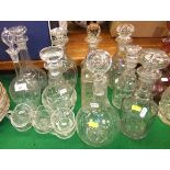 A collection of decanters and other glassware to include various 19th Century ring-necked decanters,