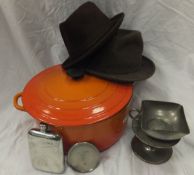 A large orange Le Creuset casserole dish and lid,