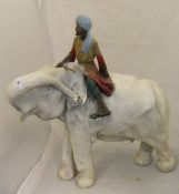 An early to mid 20th Century painted plaster figure of an elephant and mahout