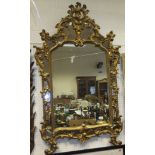 A gilt framed multi-panelled mirror with all-over acanthus leaf moulding decoration